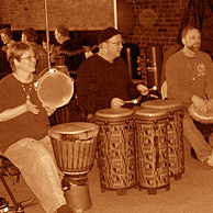 Left to right, Toni Kellar, Andy Hall, and Steve Kellar drum for the dancers at a Groove Project Drum & Dance, Marietta, OH.